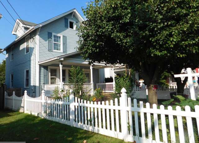 Charming single-family home in Winchester VA with front porch and white picket fence – example of homes for sale in the Shenandoah Valley.